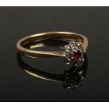 An 18ct gold ruby and diamond daisy cluster ring. Size O, 2.62g.