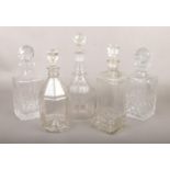 Five glass decanters.