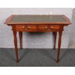 A mahogany writing desk, with leather inset top and two drawers. Desk 107cm wide, leg width 76cm.