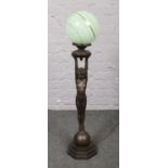 A bronze effect figural lamp, with globular glass shade. (approx 95cm height).