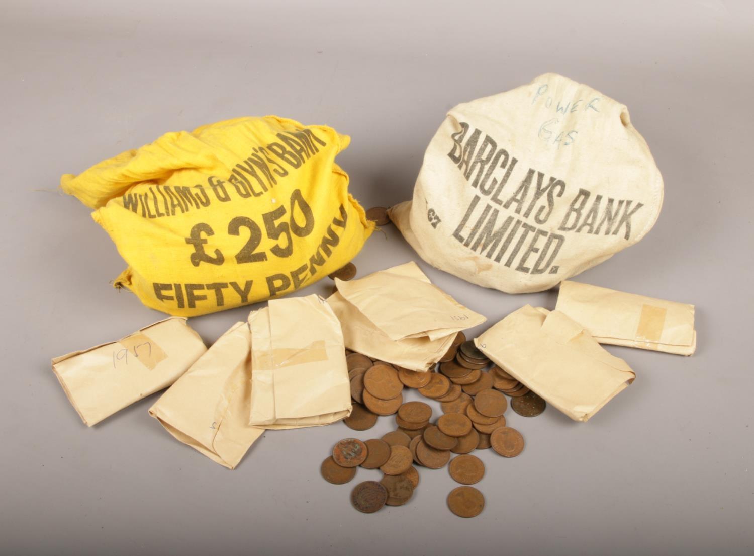 Two bank money sacks, with contents of British pre decimal coins, mainly half pennies.