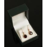 A pair of 9ct gold mounted garnet earrings.