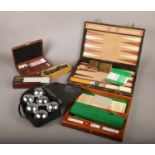 A collection of games, to include The Sailor's Dice Box, dominoes, backgammon and boules.