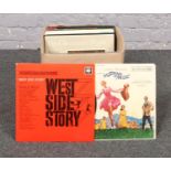 A box of vinyl records, The Sound of Music, West side story, Folk songs examples