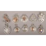 Ten silver pendants and medals to include cycling, football examples etc, 98g.