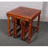 A mahogany nest of three tables, the smaller examples having drop leaf sides.