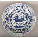 A large decorative 20th century Chinese blue and white charger decorated with a Kylin, pseudo