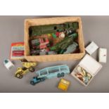 A basket of vintage play worn die cast cars including Dinky and Lesney along with religious