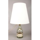 A table lamp made from a vintage glass Cognac bottle.