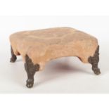 An early 20th century Regency style silk upholstered footstool raised on cast gilt metal paw feet.