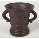 A late 17th/ early 18th century bronze mortar. With twin scrolling handles and ribbed decoration,