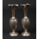 A pair of Edwardian silver specimen vases. With trefoil shaped tapering necks, decorated to the