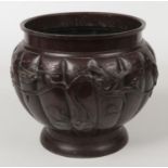 A Japanese Meiji period patinated bronze planter of lobed form. Decorated in relief with birds in