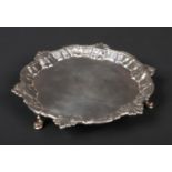 A George II silver waiter by William Peaston. With scalloped rim adorned with shell motifs and