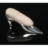 An Edwardian novelty silver pin cushion formed as a shoe. Assayed Chester 1906, 5.5cm. Slight