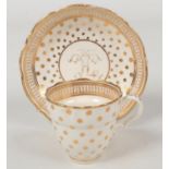 A Caughley coffee cup and saucer of ogee form and with scalloped rim. Decorated in gilt with a polka