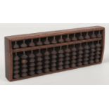A 19th century Chinese hardwood abacus with incised character marks, 29cm. Good condition.