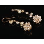 A pair of gold and diamond cluster drop earrings. Diamond weight approximately 3.5ct total, acid