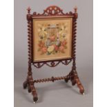 A large Victorian rosewood firescreen with square bead and woolwork panel under gilt frame. With