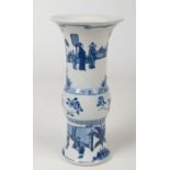 A Chinese blue and white gu shaped vase. Painted in underglaze blue with figures in an outdoor