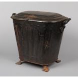 A Victorian toleware coal scuttle raised on trefoil bracket feet, 50cm high.