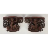 A pair of 19th century Burmese carved hardwood figural corbels / wall brackets. Each formed as a