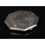 An early 20th century Chinese octagonal silver powder compact decorated with a dragon. Punch marks