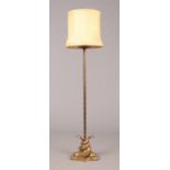 An early-mid 20th century gilt metal standard lamp. With naturalistic sconce formed from