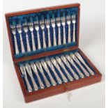 A Victorian mahogany cased set of twelve silver plated fish knives and forms by Slater Brothers. The