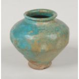 A 12th / 13th century Persian pottery small jar with turquoise glaze and dimpled mouldings, 8cm.