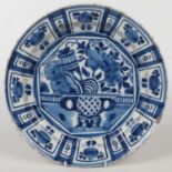 An early 19th century Dutch Delft blue and white dish. Painted in Oriental style with and urn of