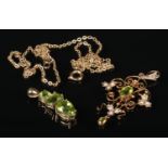 A 9 carat gold peridot and seed pearl openwork pendant and yellow metal chain and a 9 carat gold and