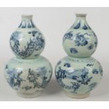A pair of 20th century Chinese blue and white double gourd vases. Painted in underglaze blue with
