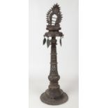 A 19th century Tibetan bronze alter stand with pierced decoration and hanging leaf formed drops,