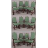 A set of twelve 20th century oak dining chairs including a pair of carved armchairs. With arched