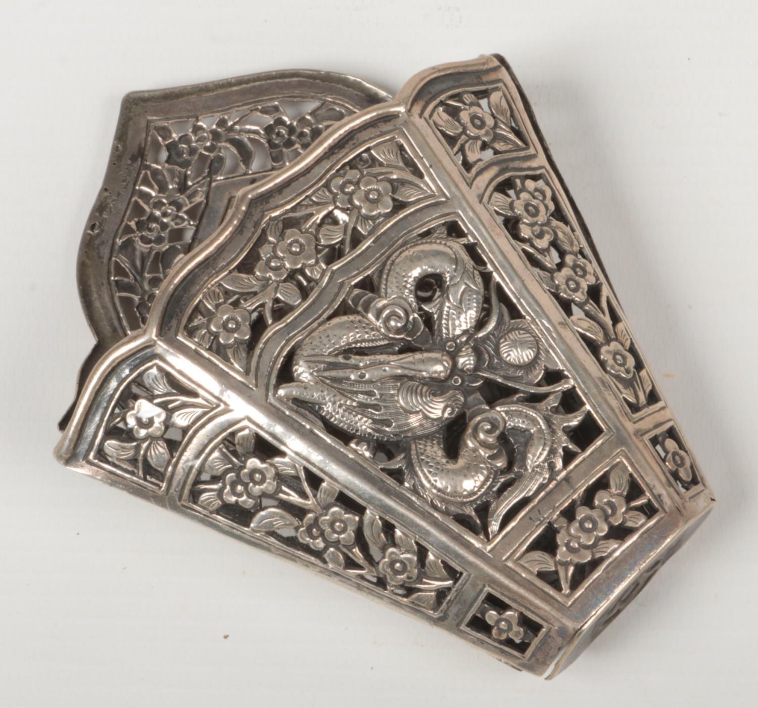 A Chinese silver openwork scabbard mount. Decorated with two dragons chasing flaming pearls on a