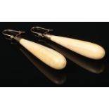 A pair of turned ivory drop earrings with gold mounts, 5cm. Good condition.