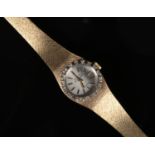 A ladies gold plated Bulova quartz Accutron bracelet watch. With diamond bezel, satin dial and baton