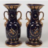 A pair of English Ironstone mazarine blue ground vases. With twin loop handles having mask