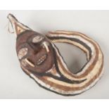 An African tribal mask with pigment decoration and tusks, 33cm.