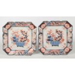 A pair of Japanese Meiji period Imari canted square chargers with scalloped rims. Each painted