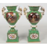 A pair of 19th century Paris porcelain pedestal mantel vases. Green ground, with twin scrolling