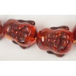A late 19th /early 20th century Chinese amber bead necklace. With oversized beads each carved in the