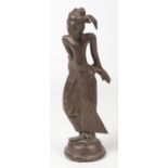 An 18th century Malaysian bronze figure with glass inset eyes and raised on a domed plinth, 26.5cm.