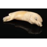 A 19th century carved ivory, gold and seed pearl mounted pendant formed as a dolphin, 4.5cm. Some