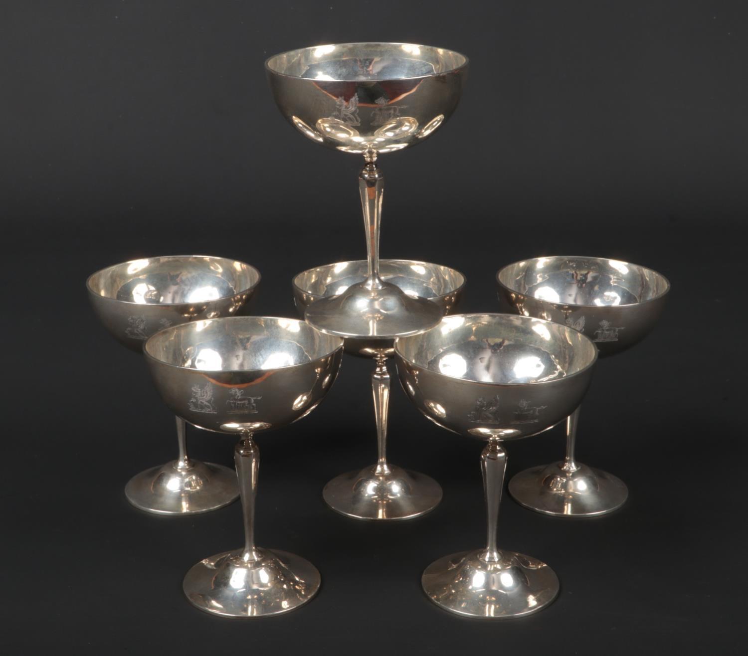 A set of six George V silver champagne saucers by Goldsmith's & Silversmith's Co. Ltd. Engraved with