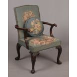 A mahogany Gainsborough type armchair in 18th century style. With original woolwork upholstery and