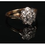 An 18 carat gold and diamond daisy cluster ring. 2.8 grams, size K. Good condition.