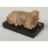 A Grand Tour Romanesque small marble sculpture of a recumbent bull raised on a rectangular slate