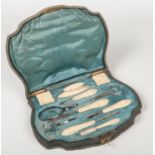 A 19th century French manicure set in fitted case. Each accoutrement mounted in carved ivory